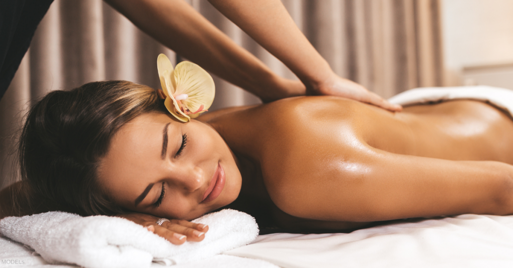 Woman laying on table getting a back massage