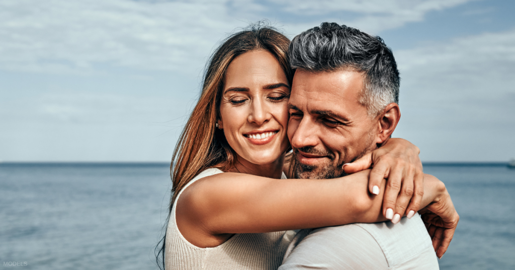 Mature couple with great hair hugging (models)