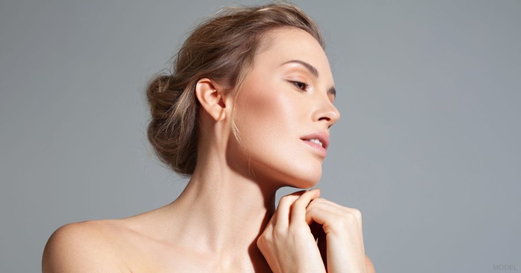 Woman with beautiful skin touching her chin (model)